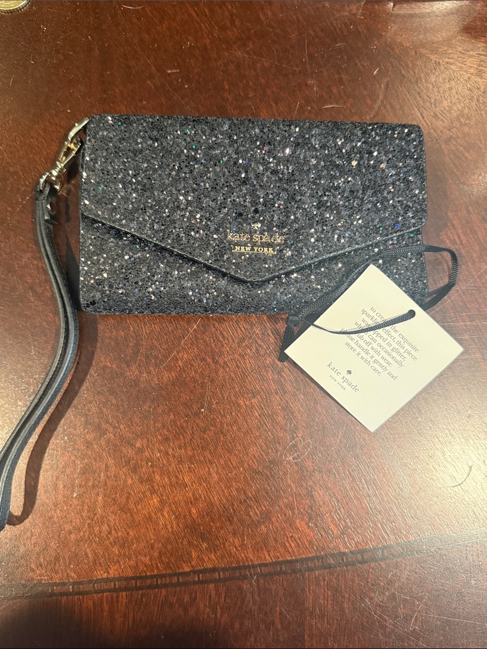 kate spade navy glitter wristlet with gold logo